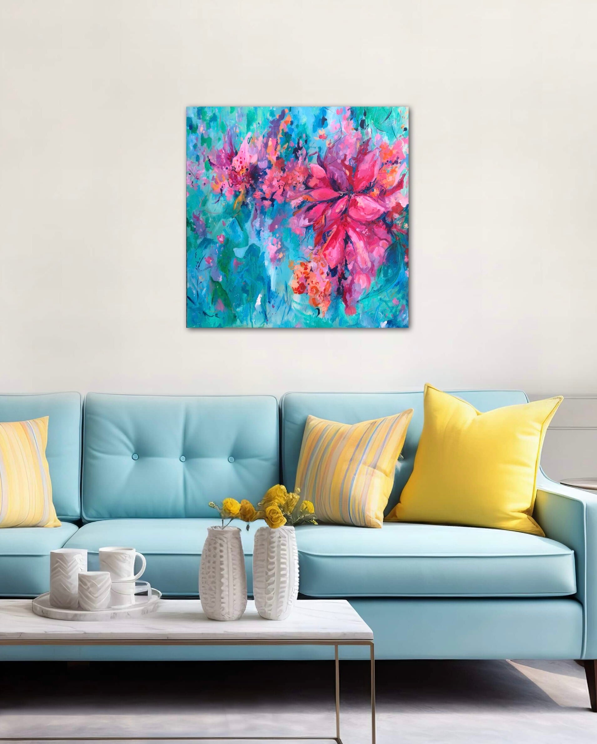 Free Spirit colourful, square shaped floral painting displayed on a white wall above a light blue sofa with yellow cushions