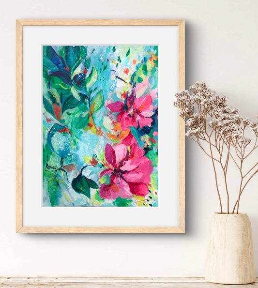 Art print of pretty pink flowers against a lush aqua and green background, framed in a natural wood frame.