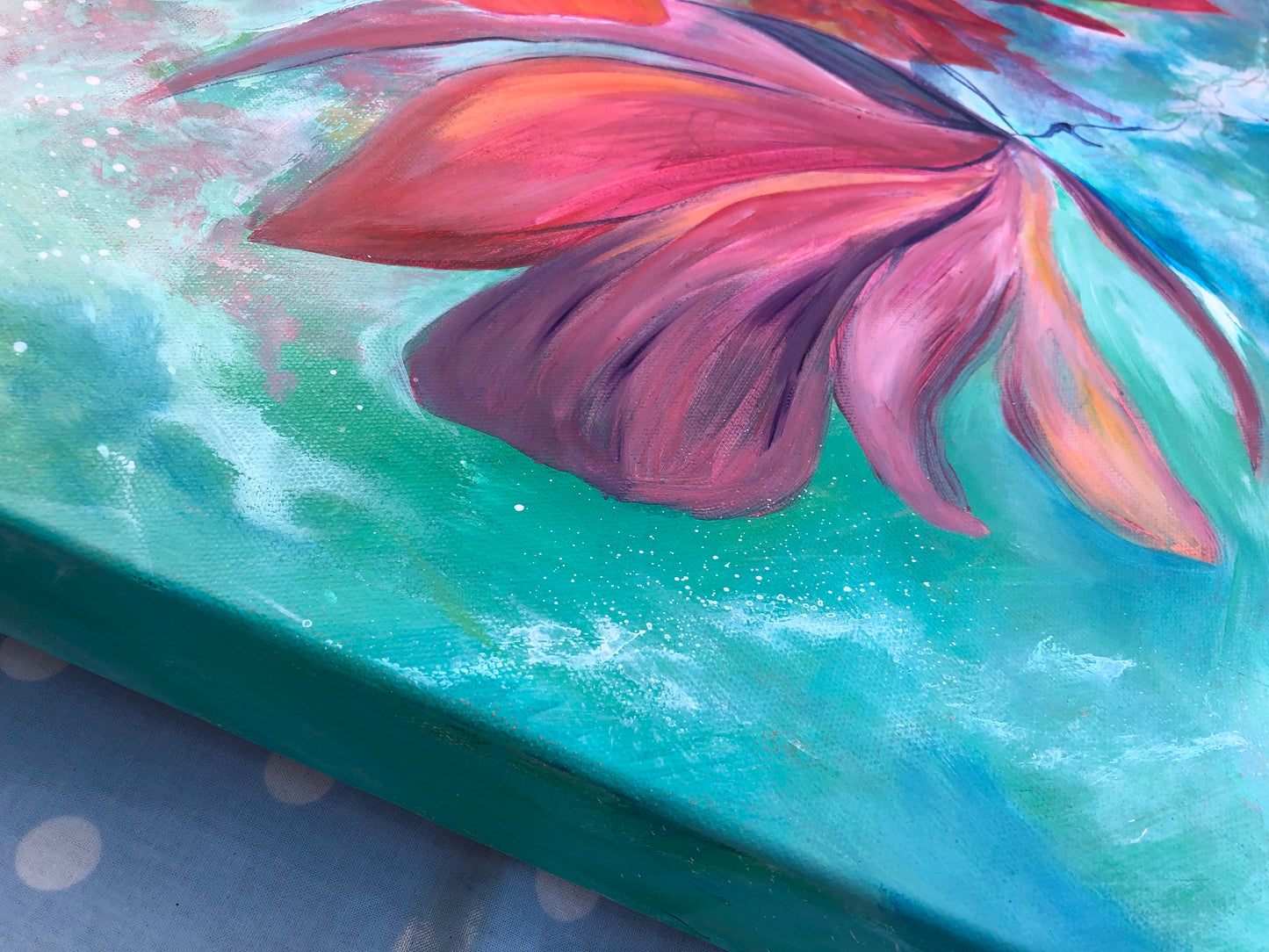 Close up detail showing side of floral canvas painting