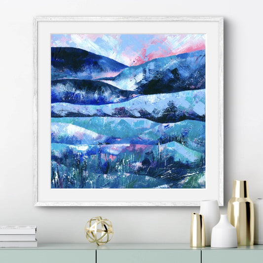 Blue and pink abstract landscape art print shown displayed in a white frame