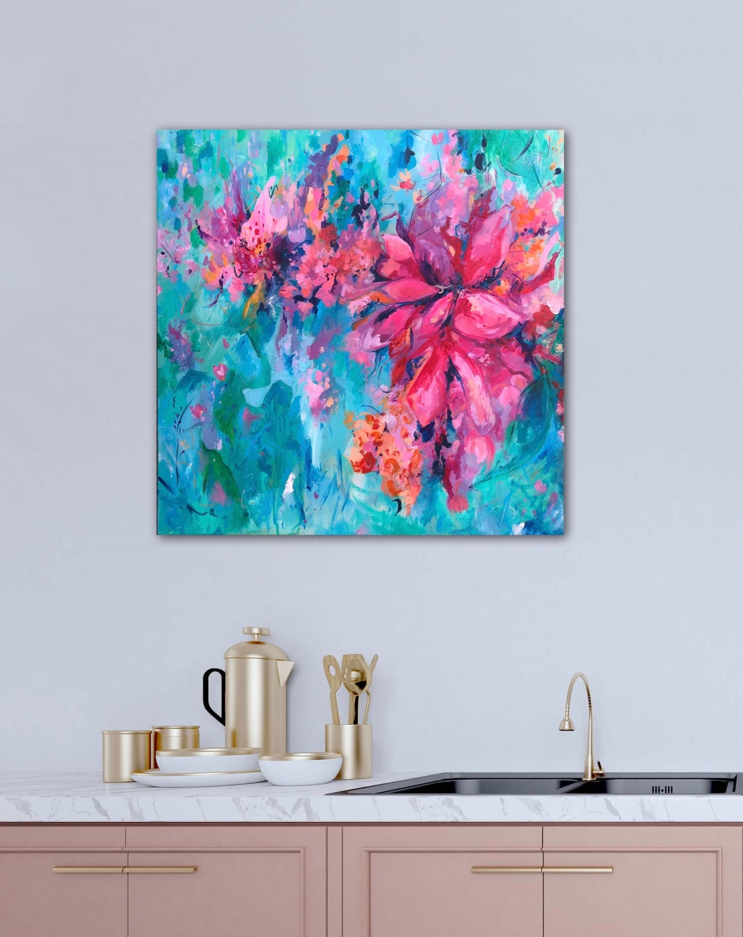 Vibrant flower painting on a neutral wall above a dusky pink kitchen