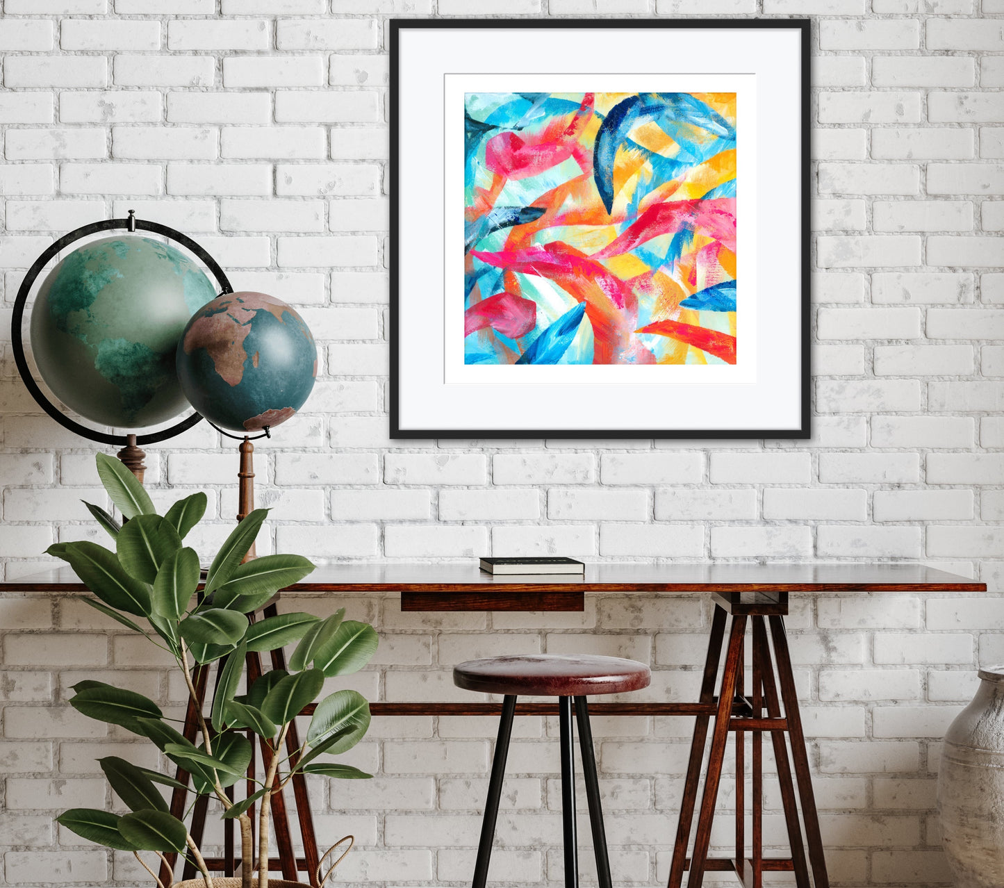 Adventure colourful abstract art print displayed in a black frame with a white mount on a wall in a contemporary office.