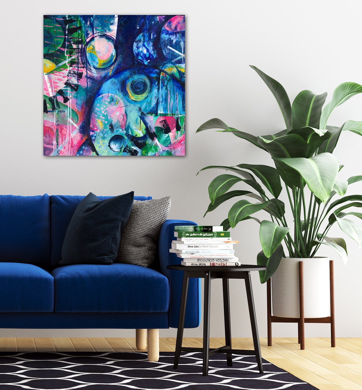 Awakening abstract acrylic painting by Melanie Howells displayed on a white wall in a contemporary room with a navy blue sofa and a large pot plant. 
