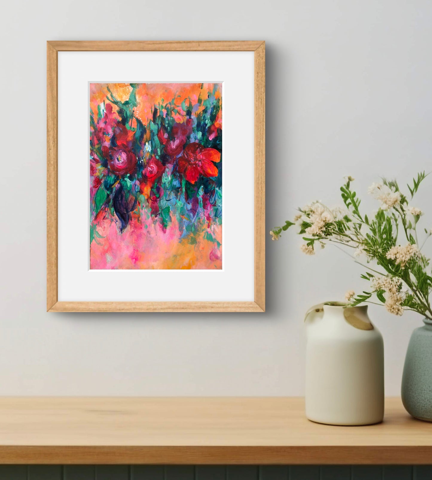 Carnival abstract floral art print framed and displayed with a white mount and in a natural wood frame. 