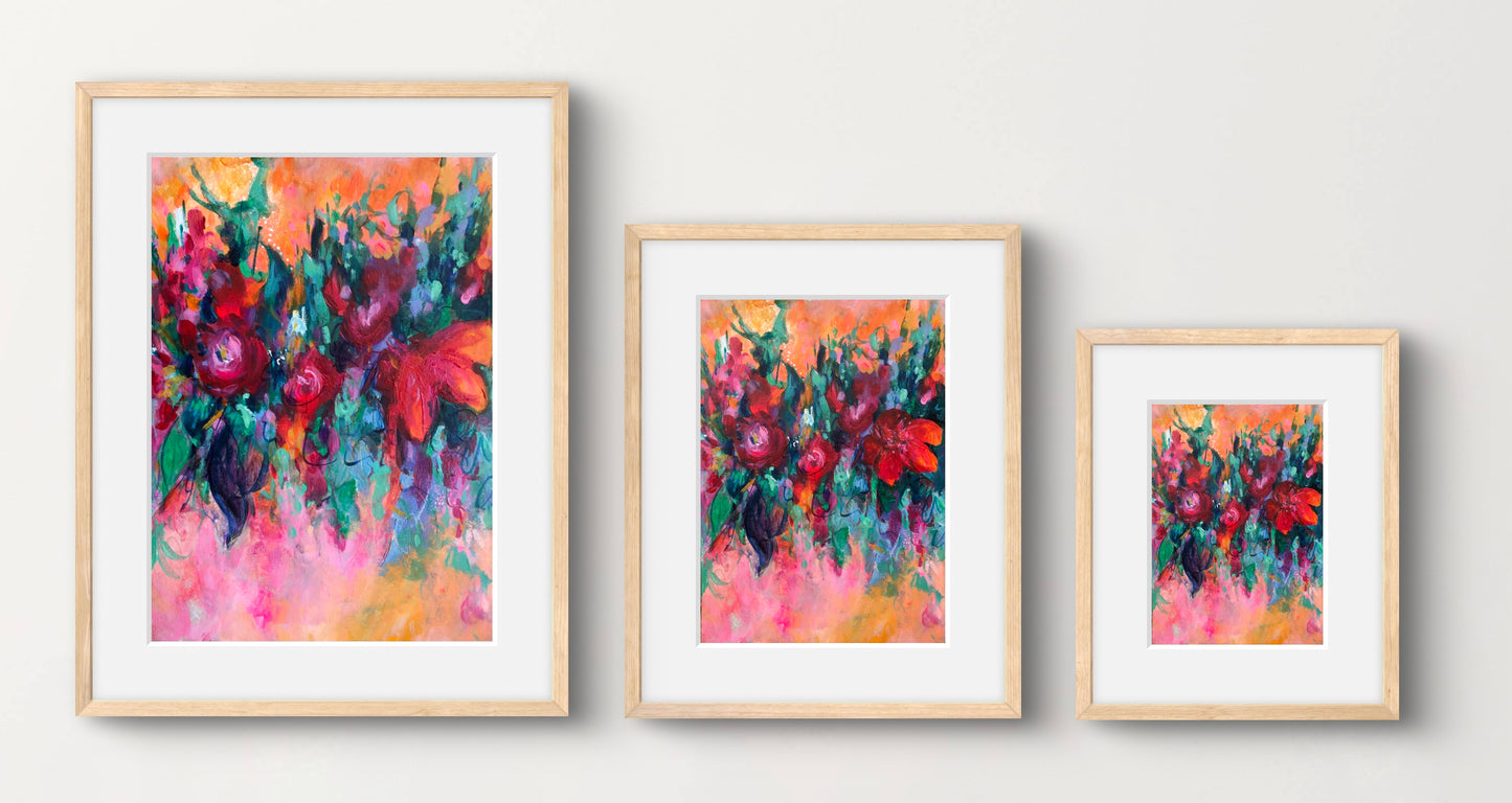 Multicoloured abstract floral art print displayed in a natural wood frame with a white mount and shown in 3 different sizes available.