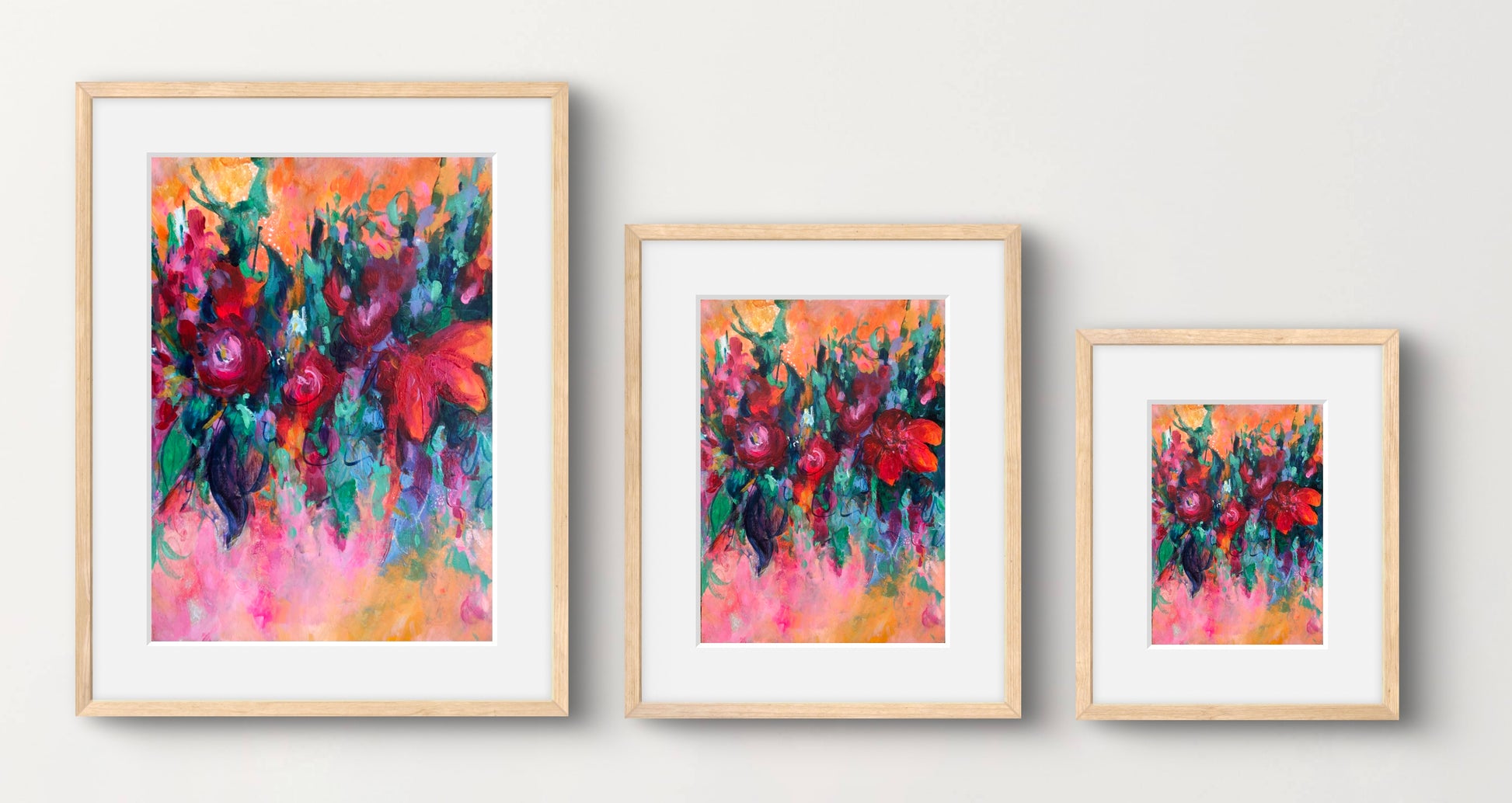Multicoloured abstract floral art print displayed in a natural wood frame with a white mount and shown in 3 different sizes available.
