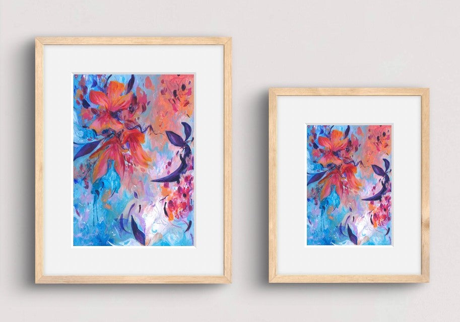 Two framed abstract floral art prints in light wood frames with white mats, displayed side by side on a light gray wall.