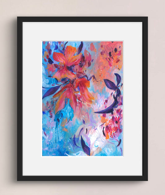Framed abstract floral wall art with expressive brushstrokes in blue, pink, orange, purple, and white, shown in a black frame with white mat against a light beige wall.