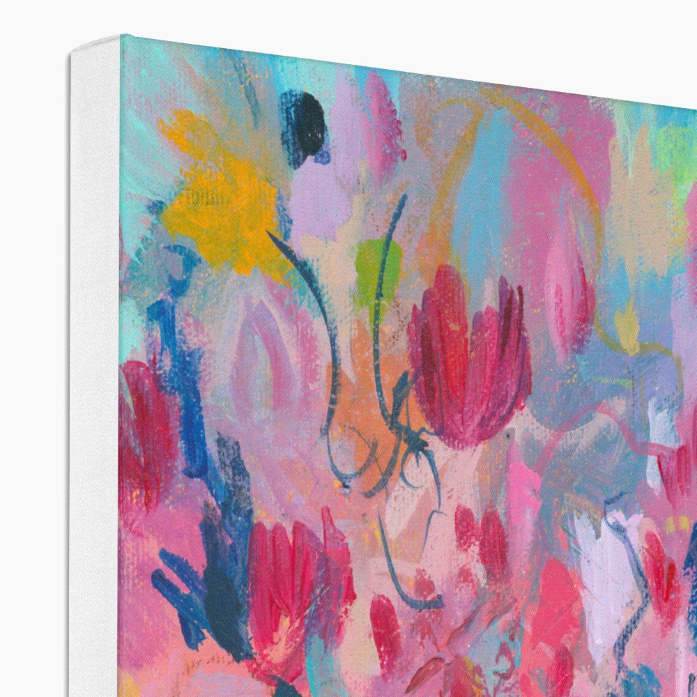 Abstract floral canvas wall art featuring expressive brushstrokes in pink, blue, yellow, and red, shown as a white edged canvas with visible side depth.
