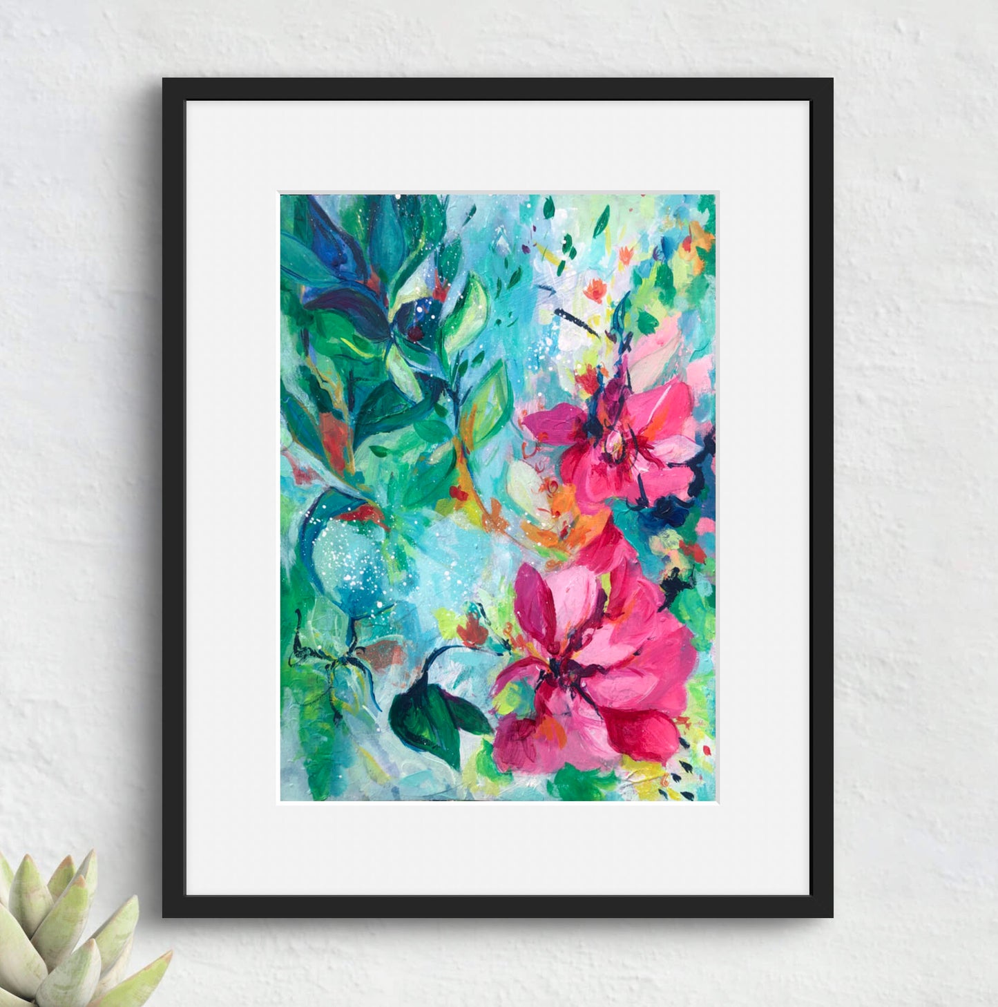 Framed colorful floral painting on a white wall
