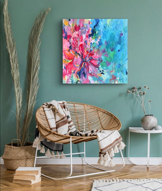 Colourful contemporary abstract floral painting on a canvas displayed against a teal wall in a lounge