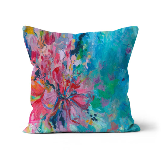 Square cushion with a pink and turquoise abstract floral design taken from a painting by artist Melanie Howells 