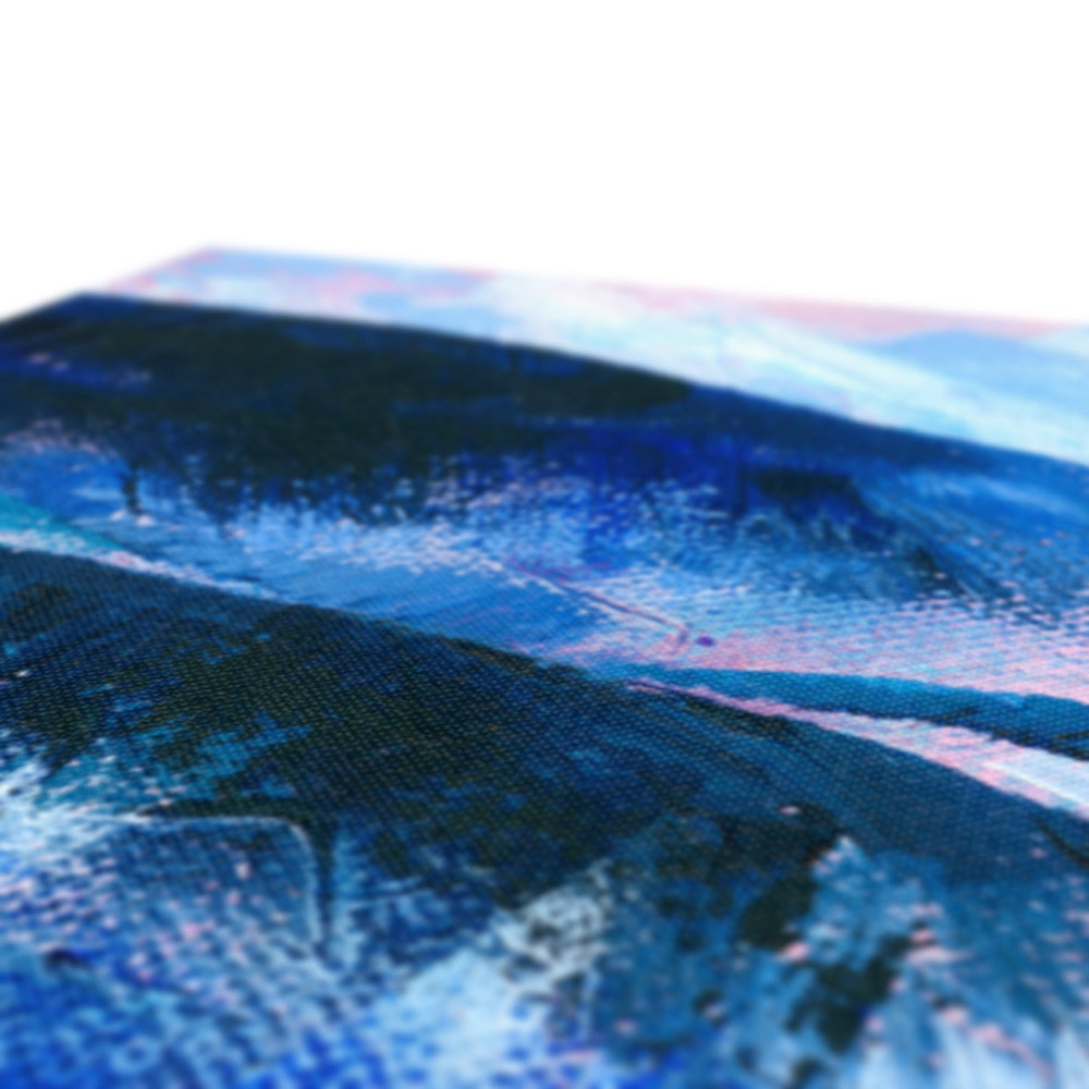 Close-up of an abstract landscape painting on canvas, showing textured brushstrokes in deep blue, navy, black, and soft pink tones.