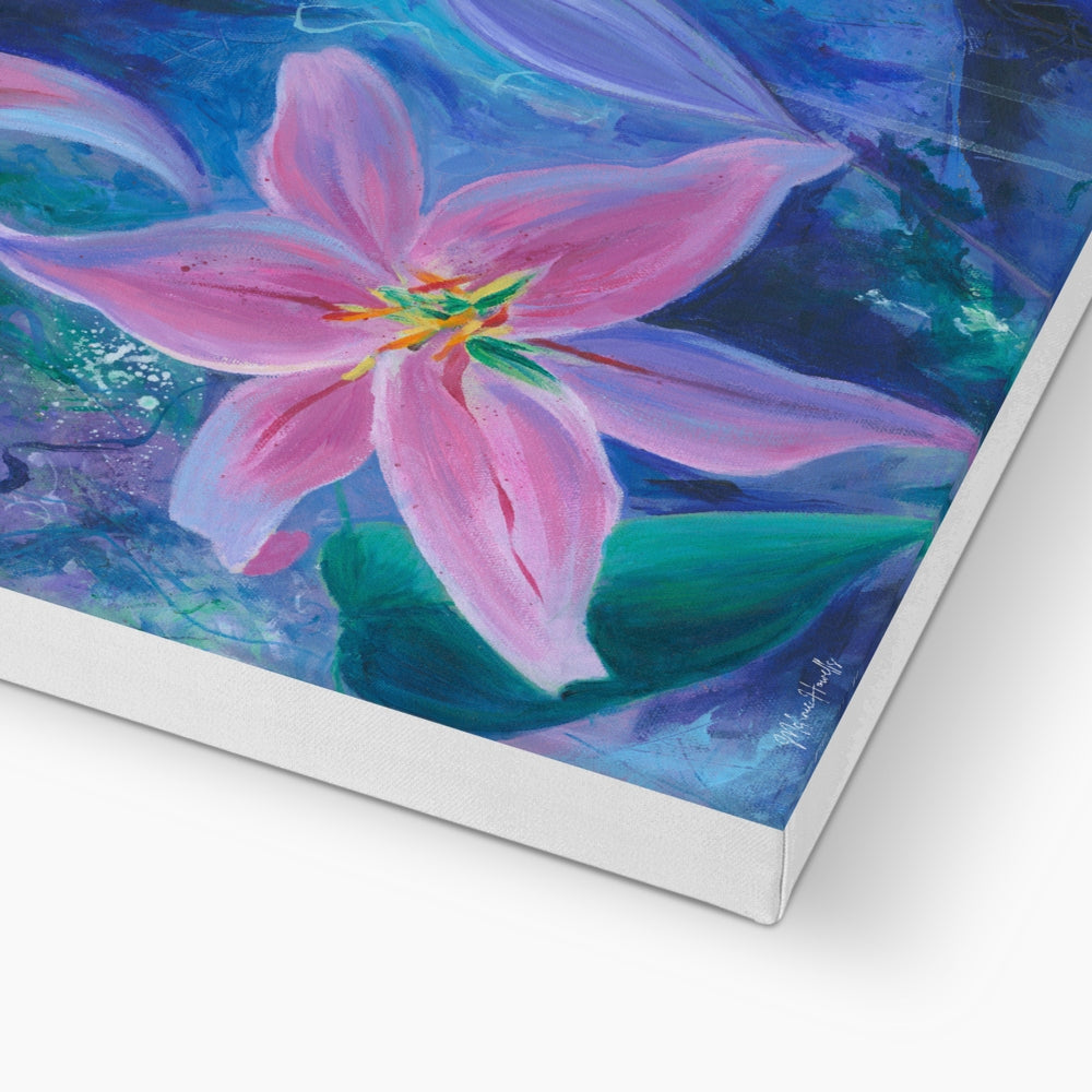 A square canvas painting of a pink lily flower with green leaves and a blue-purple background, shown at an angle with the white canvas edge visible against a white surface.