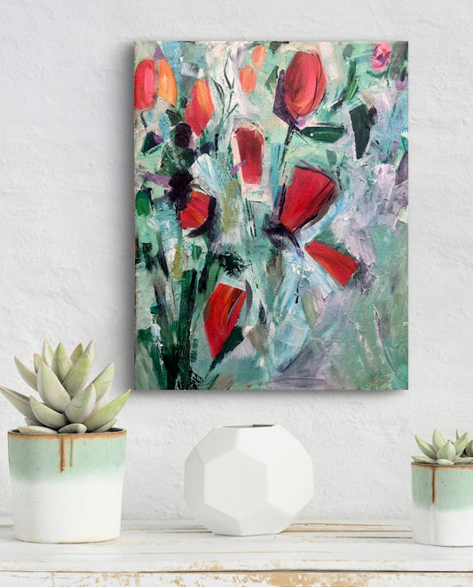 Abstract painting with red flowers on a white wall above a shelf with decorative items.