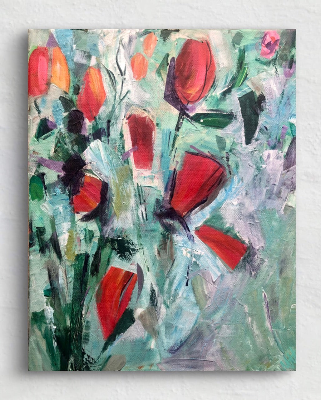 Abstract painting with red flowers and green leaves on a light background