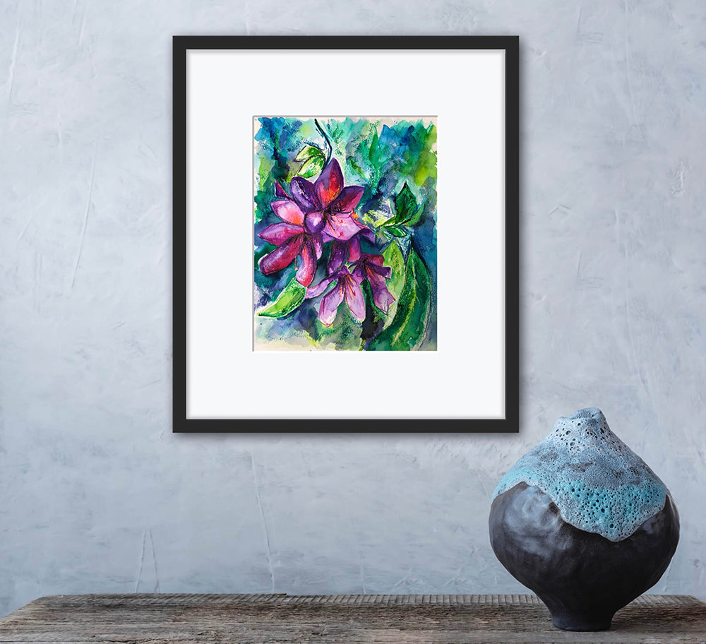 Rhodedendron original watercolour painting by Melanie Howells displayed framed with a white mount and simple black frame on a grey wall next to a vase.