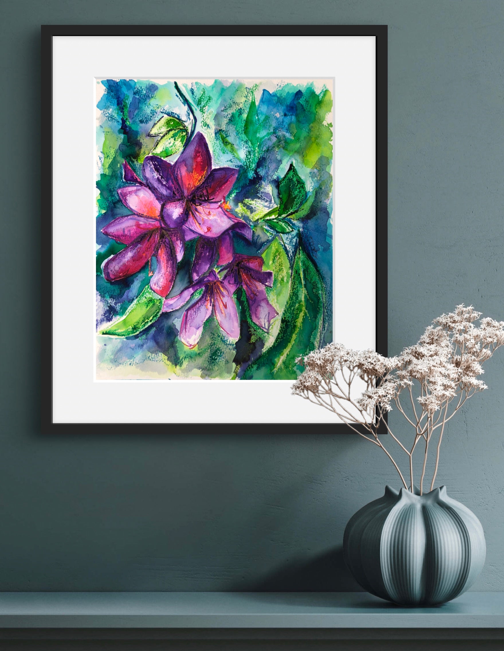 Vibrant and lush Rhododenron watercolour and oil pastel painting in a black frame with a white mount against a dramatic painted wall.
