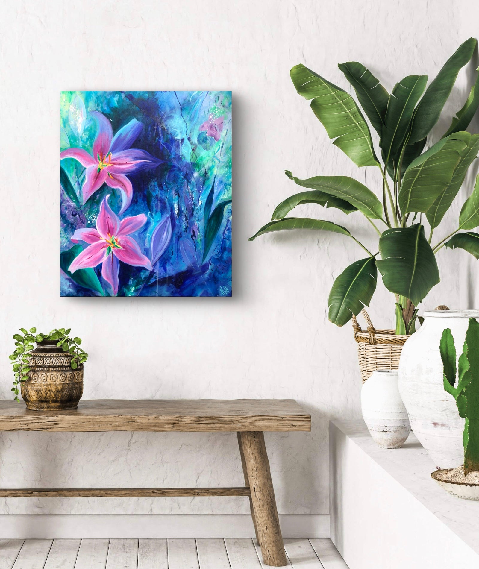 Vibrant acrylic painting on canvas of pink lily flowers against an almost tropical background of rich blue and greens displayed on a white wall surrounded by lush green plants