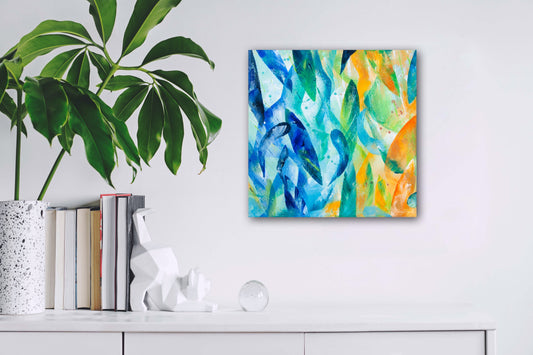 'Synergy' original colourful acrylic painting measuring 30x30cm displayed on a white wall next to a pot plant