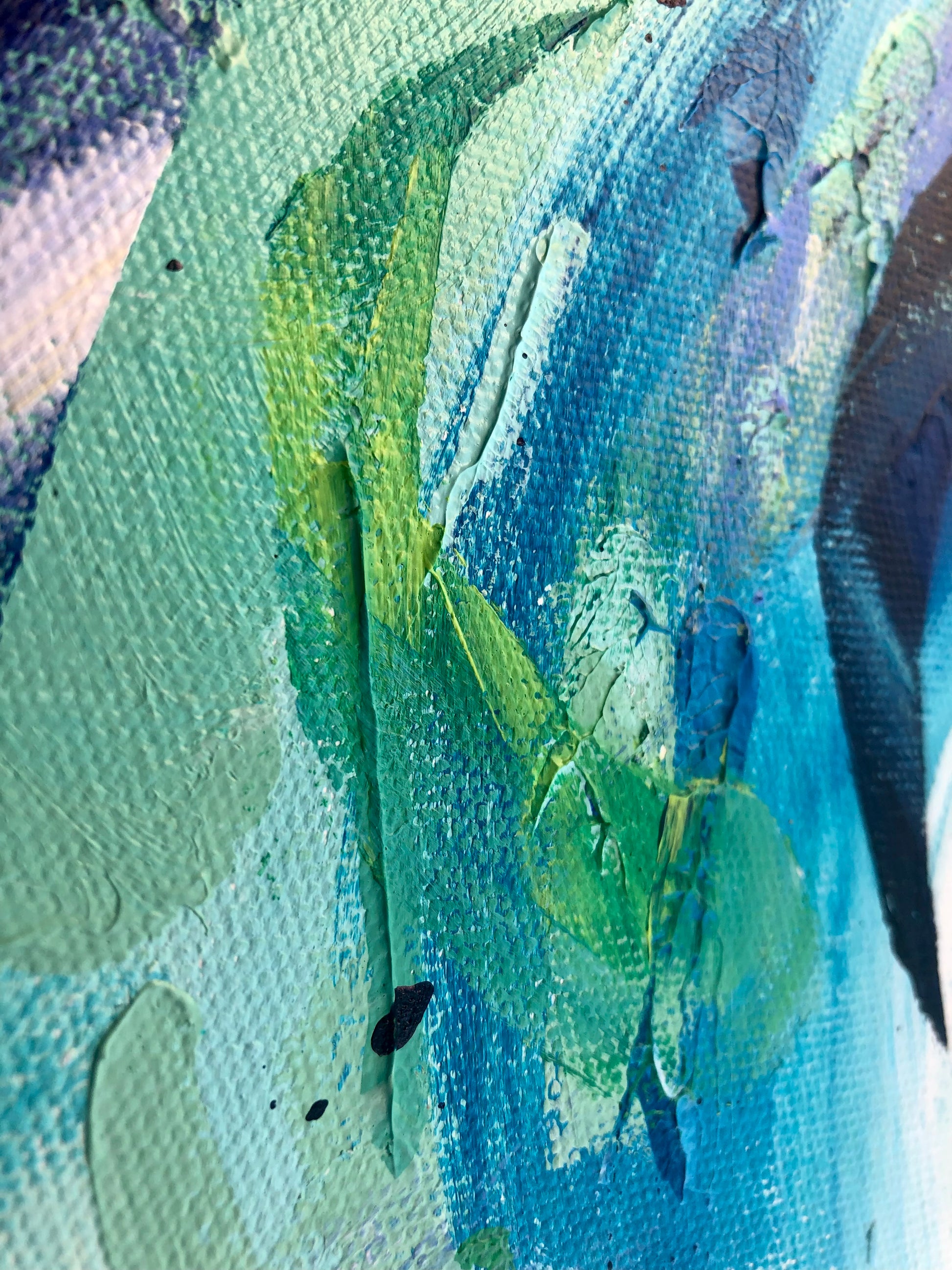 Close-up of painting details from an original acrylic painting in shades of blue and green 