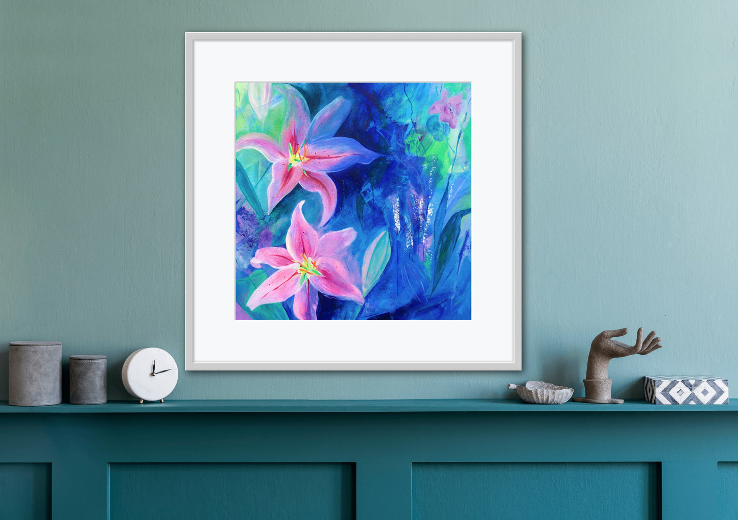 Square Lilies in Bloom floral fine art giclee print displayed in a white frame with a mount on a teal wall above wood panelling that is painted teal