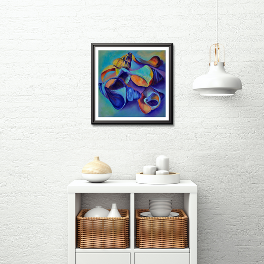 A Pocketful of Shells colourful seashell art print displayed in a black frame on a white brick wall above a shelving unit with wicker baskets 